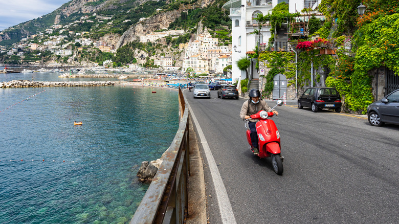 Man riding a Vespa on the Amalfi Coast in Italy