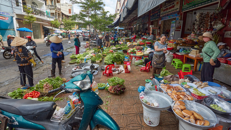 Outdoor marketplace in Buon Ma Thuot, Vietnam with produce and Vietnamese foods