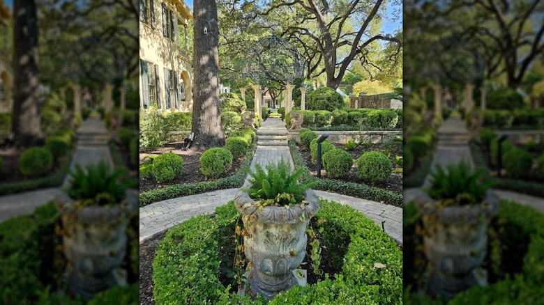 A garden walkway surrounded by trees at Villa Finale