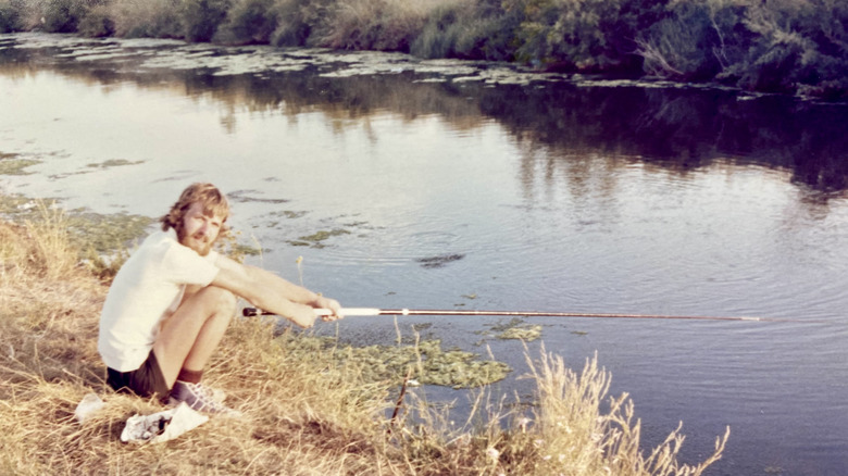 A retro photo of a young man fishing