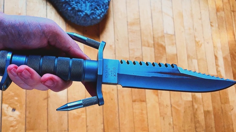 Hand holding BuckMaster 184