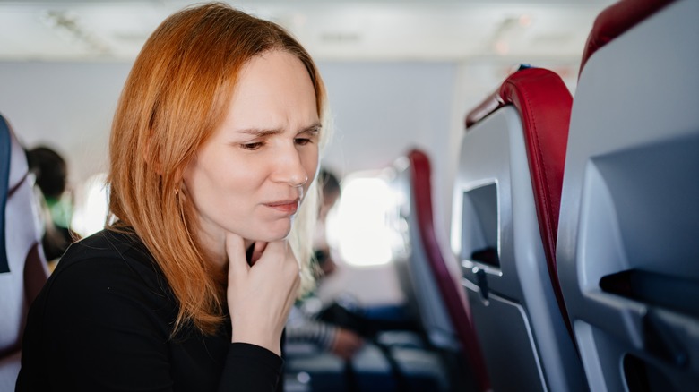 Woman holding through on plane