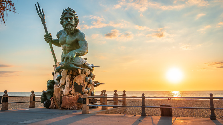 A statue of seagod Neptune at sunset