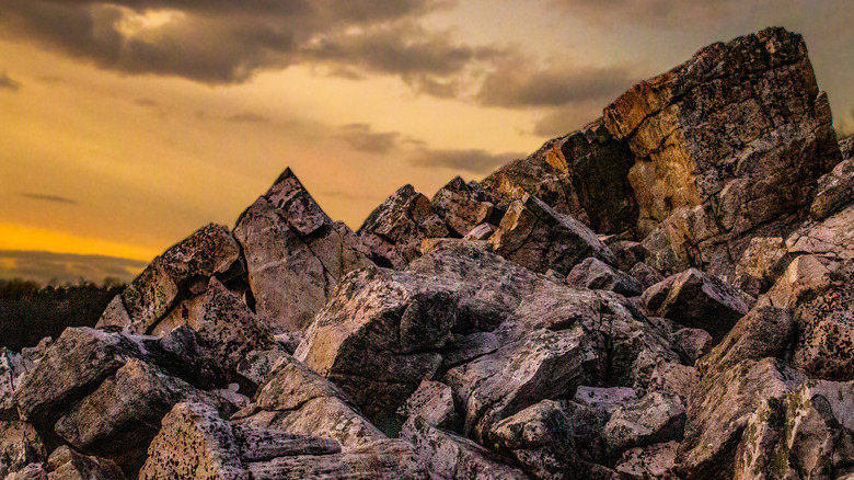 Boulders at the Devil's Marbleyard against a yellow sky