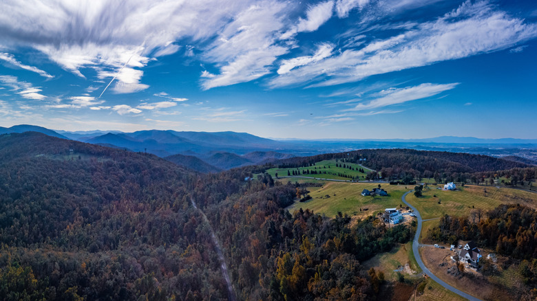 Mountains with a road winding through it and blue sky with clouds
