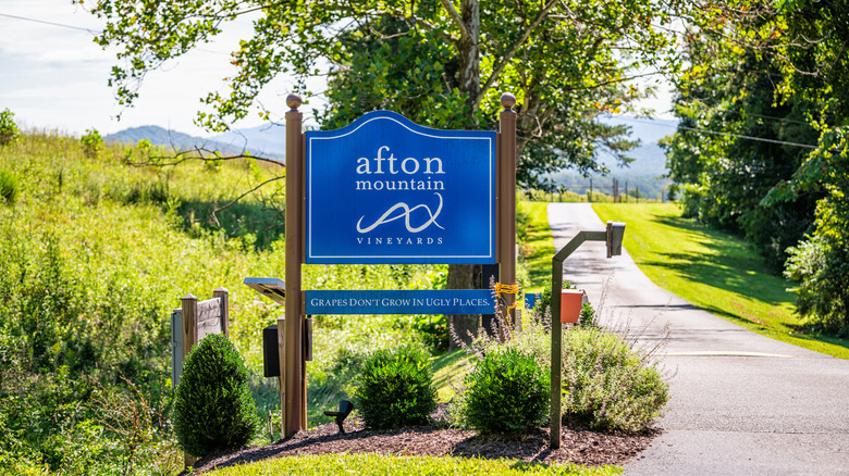 Afton Mountain Vineyards sign with greenery in the background