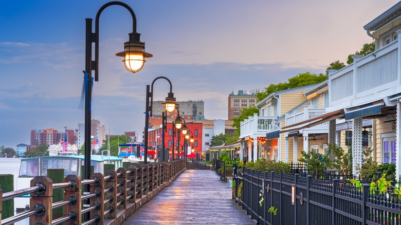 Seaside walkway with street lamps and wooden houses
