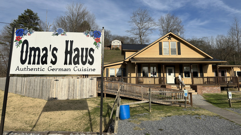 Oma's Haus Authentic German Cuisine restaurant sign outside of a tan building in Coeburn, Virginia