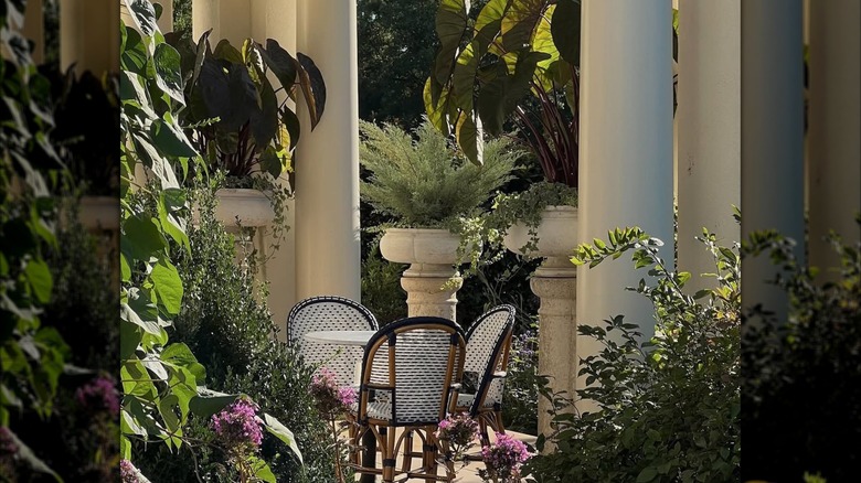 An outdoor terrace at Keswick Hall surrounded by flowers in summer