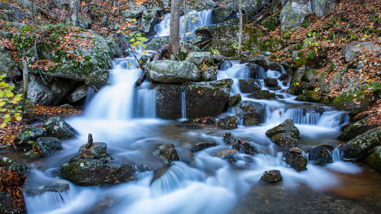 Water cascades over rocks at Crabtree Falls, Virginia.