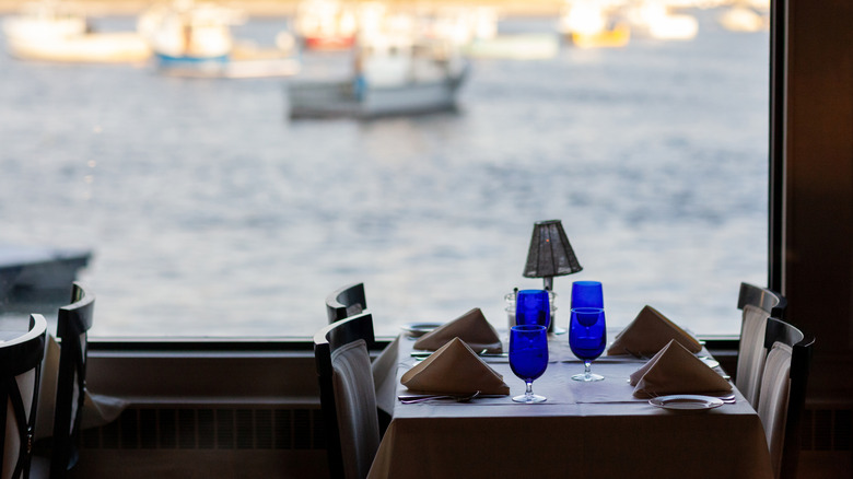 Restaurant table set for diners with waterfront views