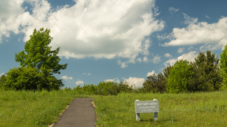 A sign and paved path at Big Spy Mountain Overlook
