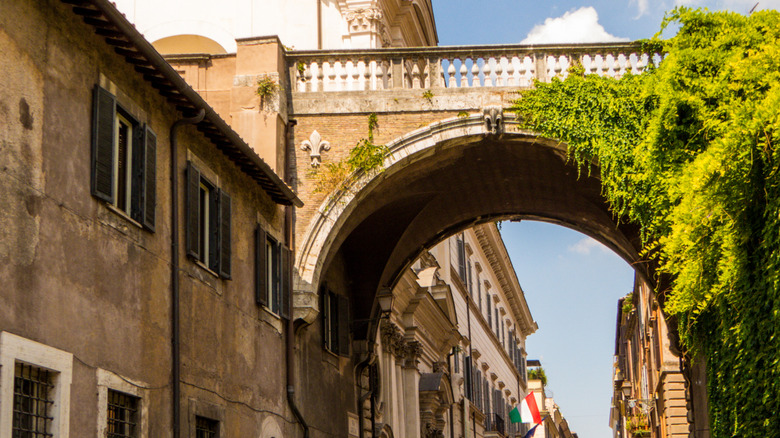 Arco Farnese spans Via Giulia in historic center of Rome