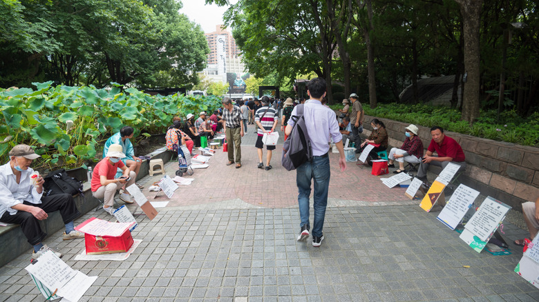 Placards line the streets of Shanghai's marriage market in People's Park.
