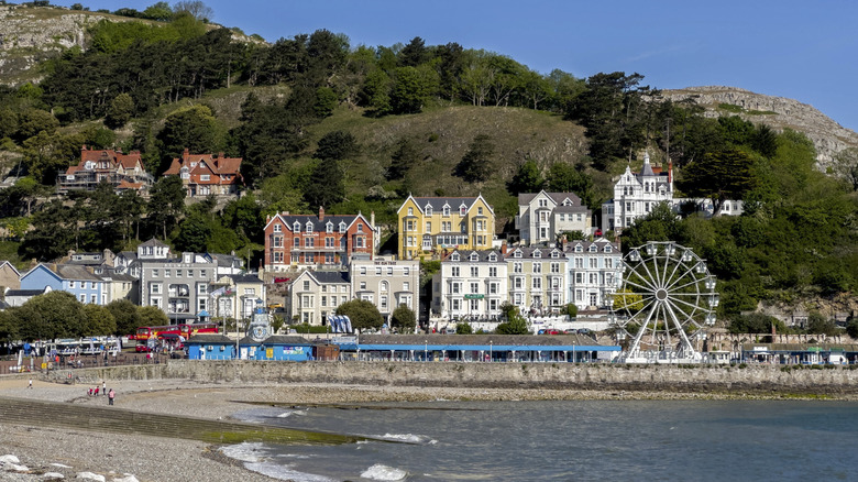 A view of LLandudno, Wales, from across the water and shore, to the quaint historic hillside buildings