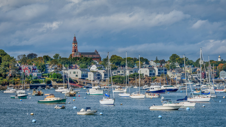 overcast sky over boats on blue water