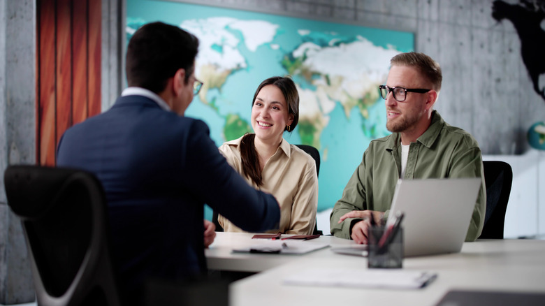 Couple consulting with travel agent.