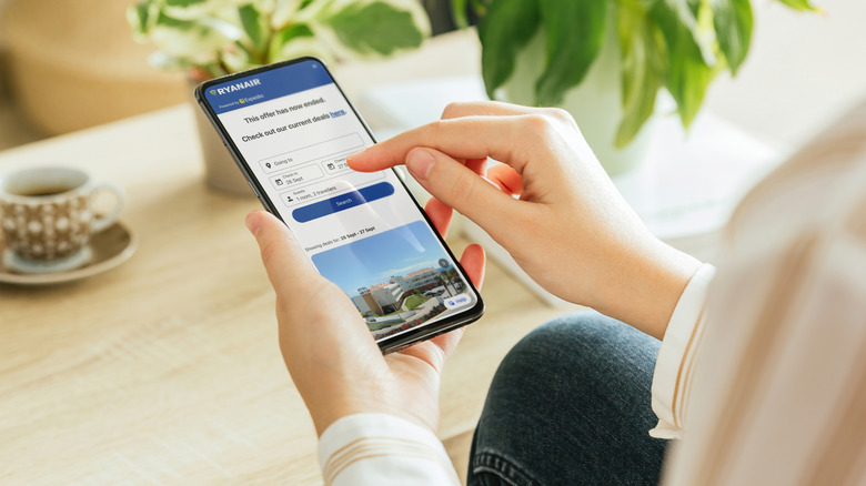 Person booking a flight online on a mobile phone