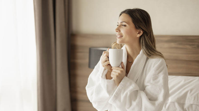 Woman holding cup in hotel