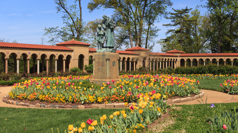 A statue of St. Francis surrounded by flowers at the Franciscan Monastery in Brookland, Washington, D.C.