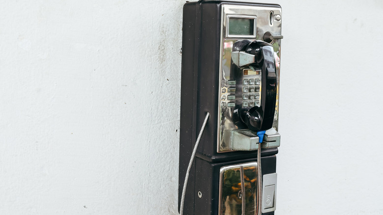 A wall mounted payphone