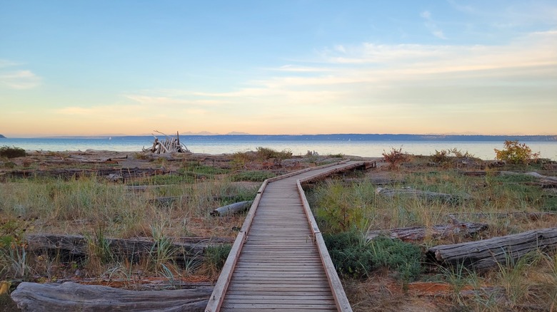 The boardwalk to the beach at Fay Bainbridge Park, Washington, with views of Puget Sound during sunset
