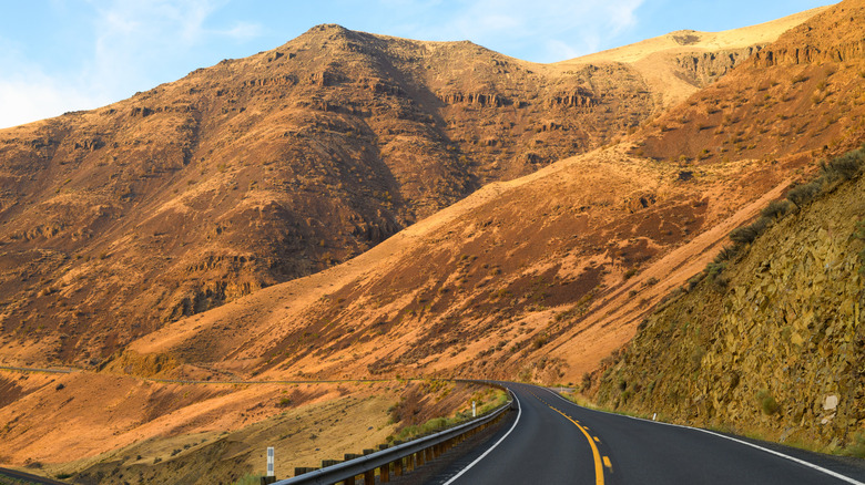 Road running parallel to canyon and mountain range