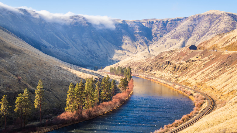 Blue river snaking through desertic hills