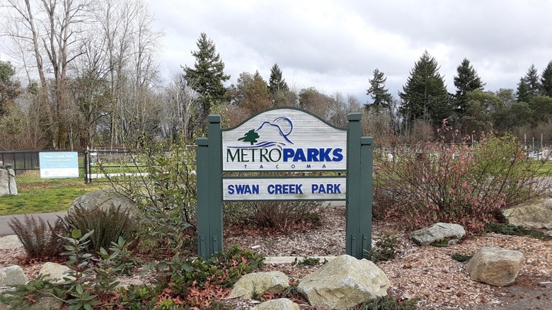 The Metro Parks Swan Creek Park sign welcomes visitors in front of the dog park.