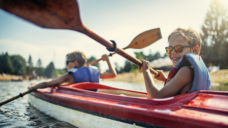Two boys out in a kayak enjoying the day