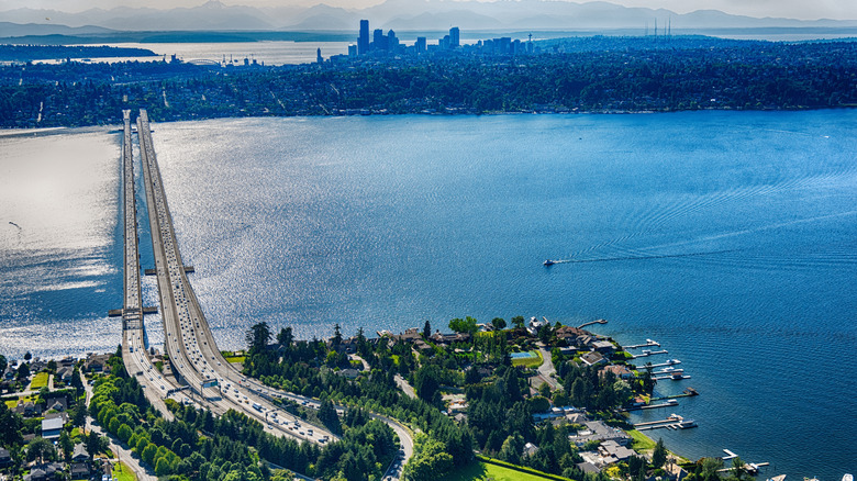Aerial view of Downtown Seattle and a nearby island suburb connected by a long bridge over Lake Washington.