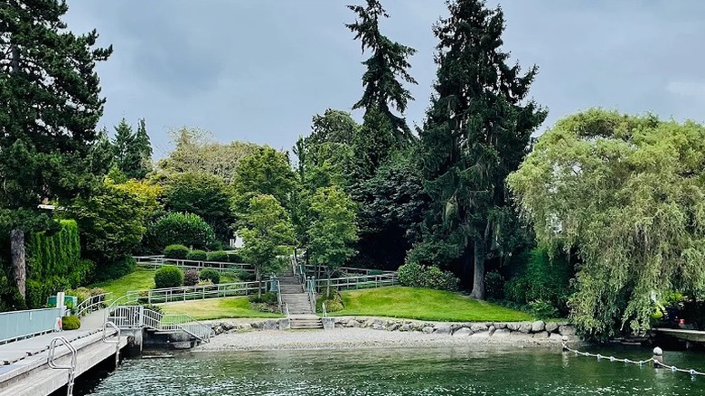 A dedicated swimming area at Road End Beach with grassy lawns, stairs and surrounding trees.