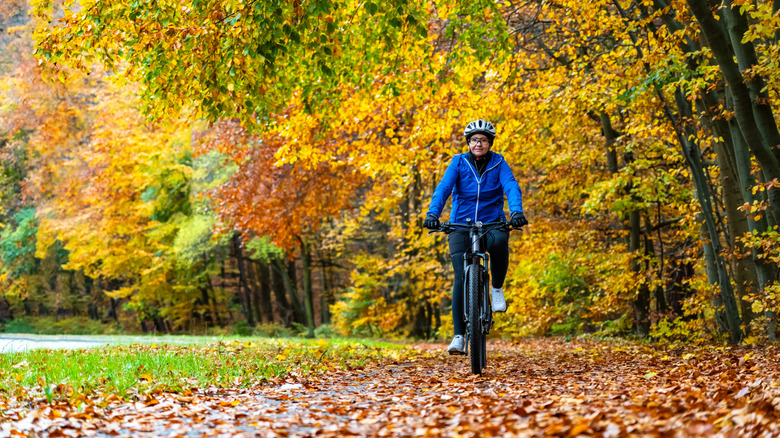 Cyclist riding on a trail through beautiful fall foliage