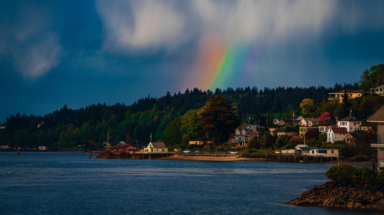 A rainbow above houses overlooking the water in Port Orchard, Washington.