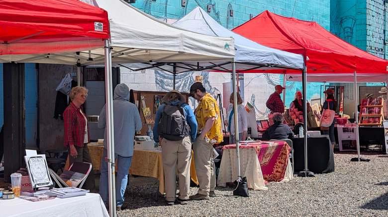Vendor stalls set up during a market with people selling arts and crafts in Port Orchard.
