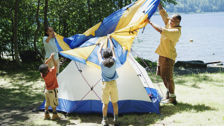 family setting up campsite
