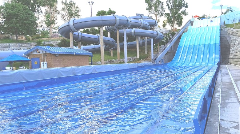 blue tube water slide next to blue body slide
