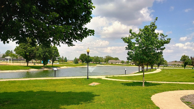 Lakeview Park in Watseka, with a pond with a fountain surrounded by grass and trees