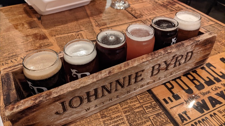 Beer flight from Johnnie Byrd Brewing Company, Wayne, Nebraska, with old newspapers covering the table