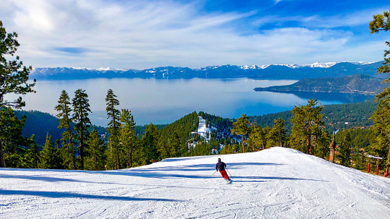 Skiers on a mountain overlooking Lake Tahoe