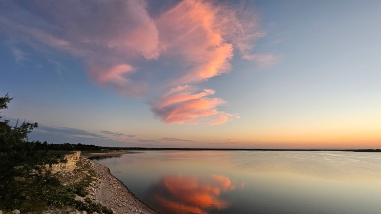 Webster Reservoir at Webster State Park, Kansas, reflecting the pink sunset sky