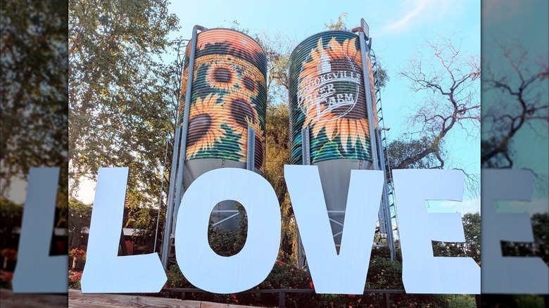 Sunflower tanks and a "Love" sign at Brookville Beer Farm in Maryland
