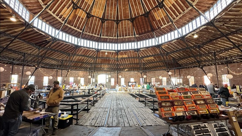 A wooden roundhouse with vendors