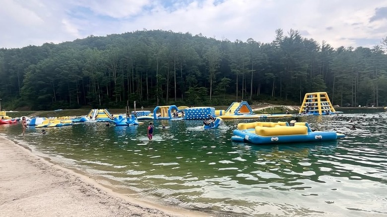 Guests enjoy the lake water park at ACE Adventure Resort in Oak Hill, West Virginia