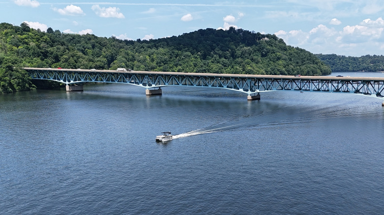 A pontoon boat passes under a bridge on Cheat Lake, West Virginia