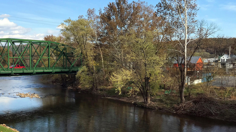 City of Capon Bridge the with a bridge over the Cacapon River with The River House to the right