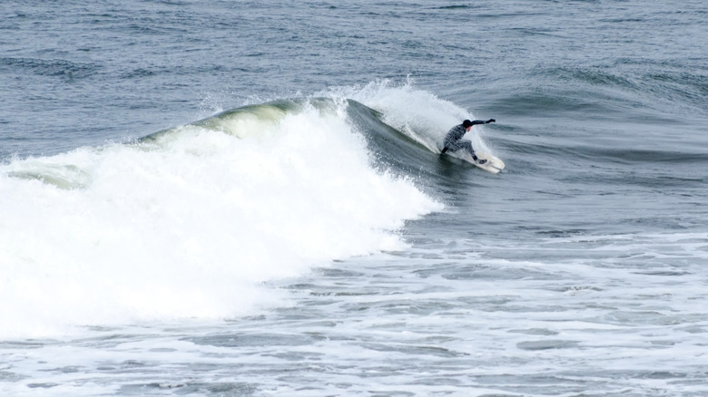 Surfer at Westhaven Beach inside Westport Light State Park, Washington