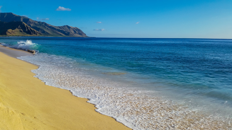 Yellow sand beach with mountains