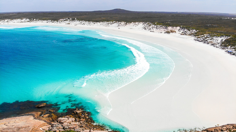 White sand and bright blue water at Wharton Beach in Australia