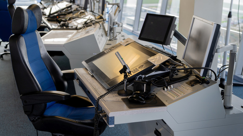 An empty desk inside an air traffic control room